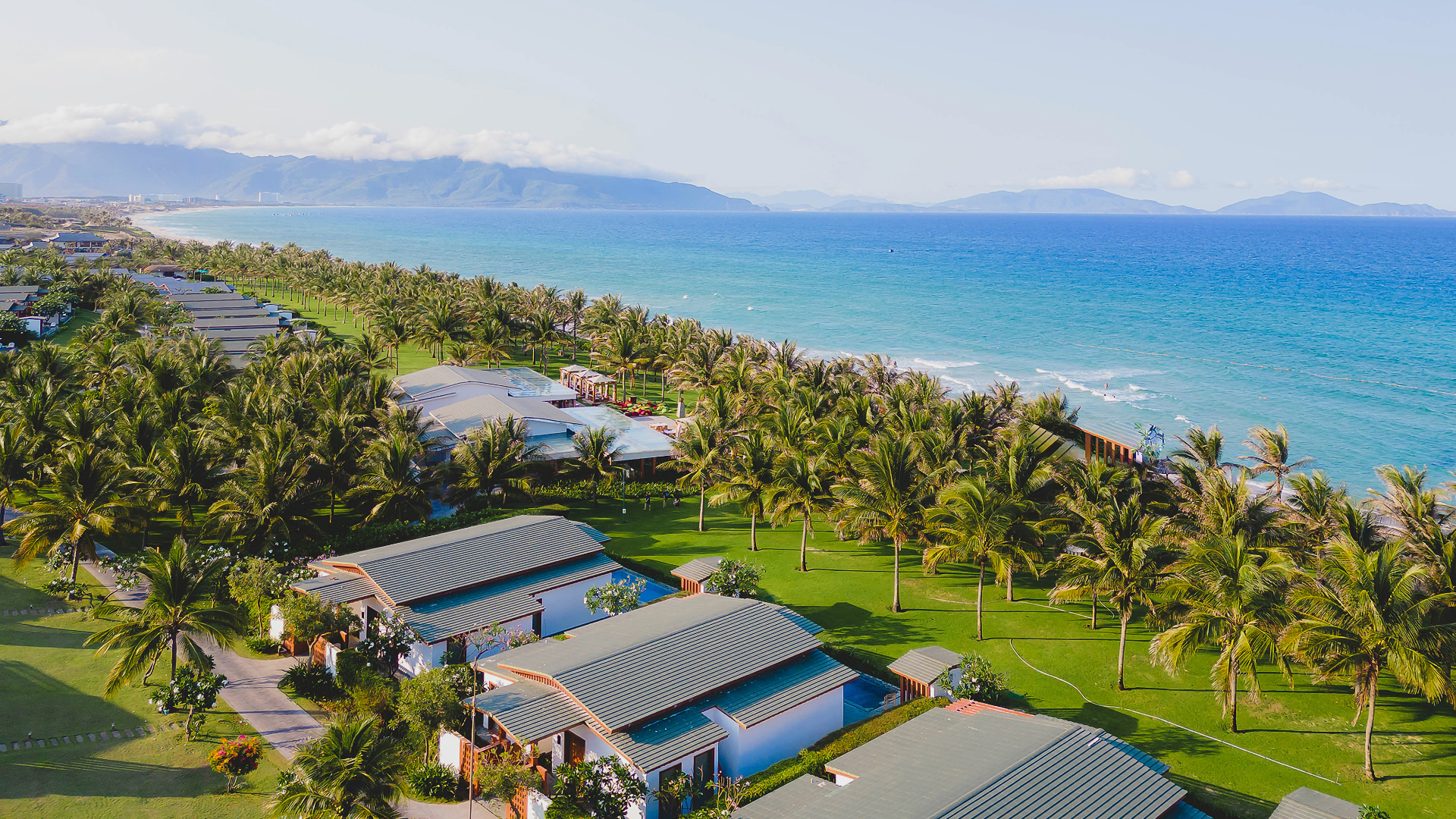 Enjoy the biggest Member Private Sale for ALL members at Mövenpick Resort Cam Ranh landscape with blue beach and the greenest tropical lawn.