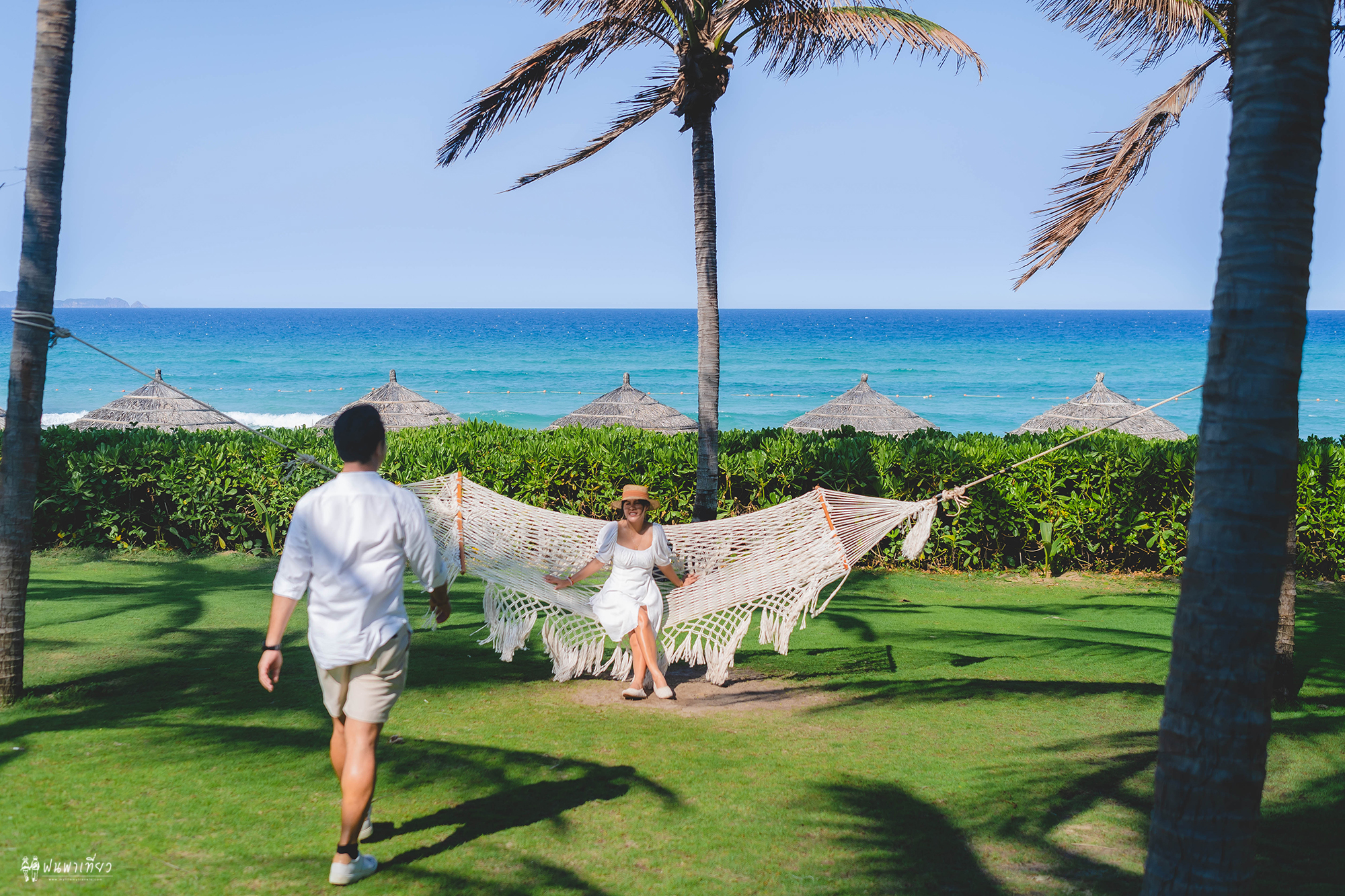 Couple hanging out in the tropical garden by the beach at Tropicana Beach Club of Movenpick Resort Cam Ranh